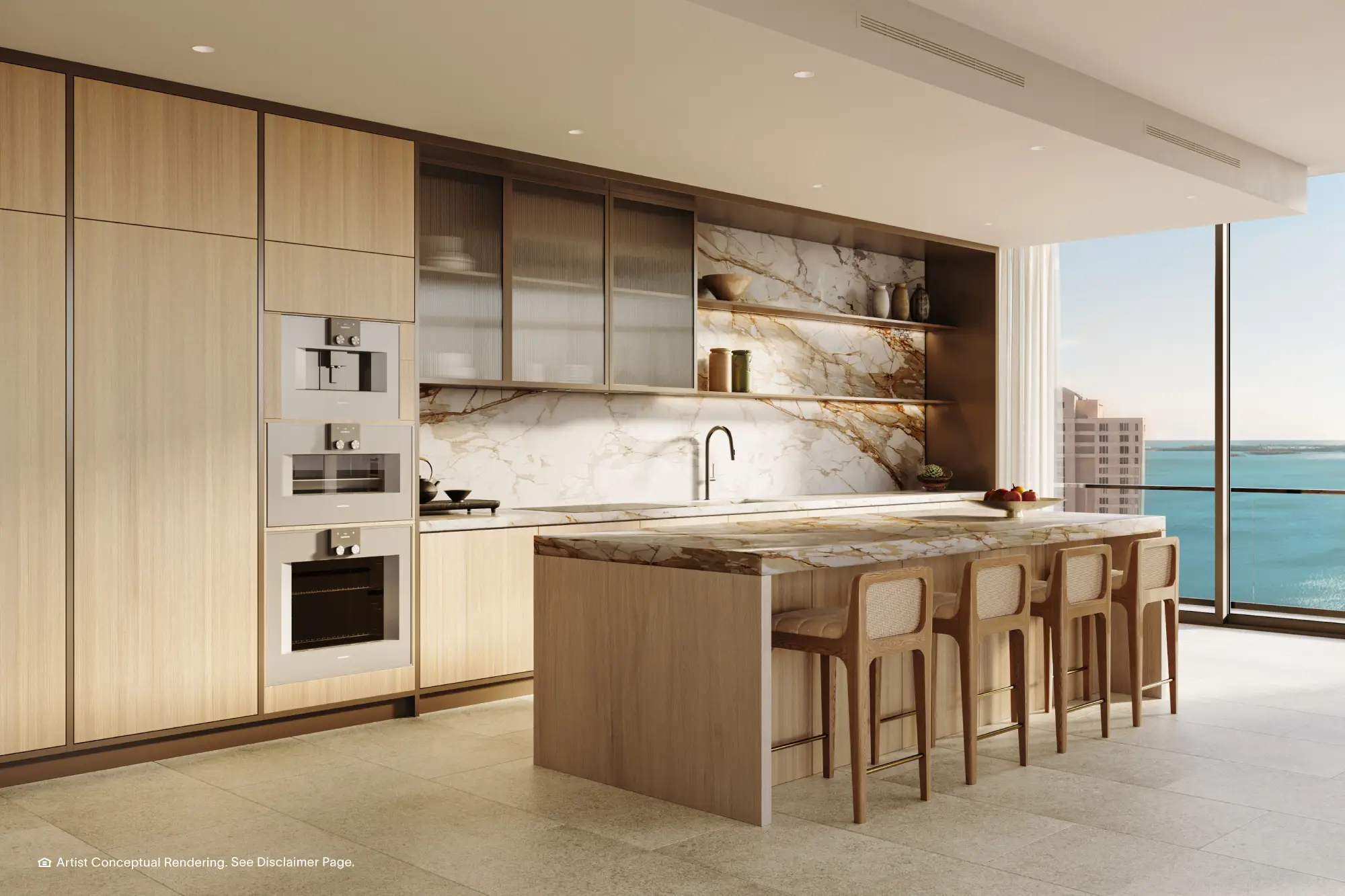 Cocina de una residencia de la Torre Norte con isla de mármol y vista al mar